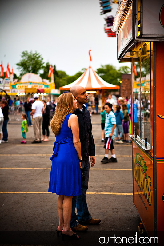 Engagement Shoot at the Carnival - Kim and Aaron - buying ride tickets