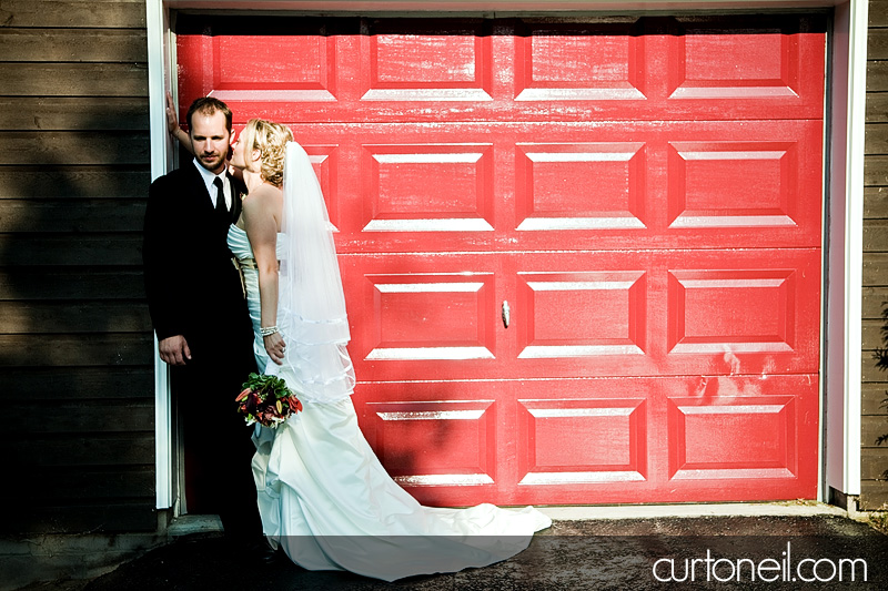 bride and groom red garage door - st. joe's island wedding