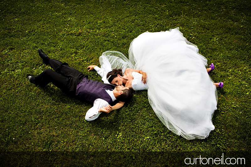 Sault Ste Marie Wedding Photography - Jess and Kyle - sneak peek laying in the field