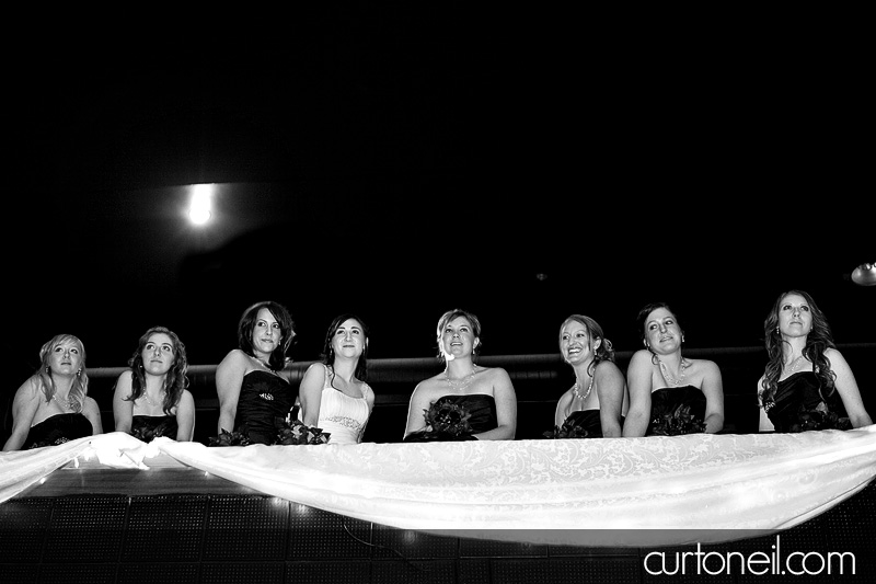 Winter Wedding - bride and bridesmaids on balcony - Curt O'Neil Lifestyle Wedding Photographer