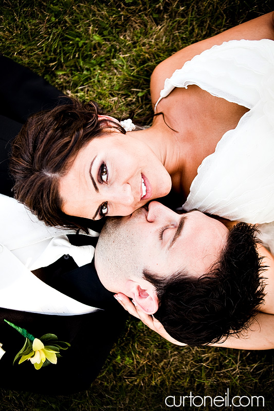 Sault Ste Marie Wedding Photography - Sandy and Skip wedding sneak peek laying in the grass