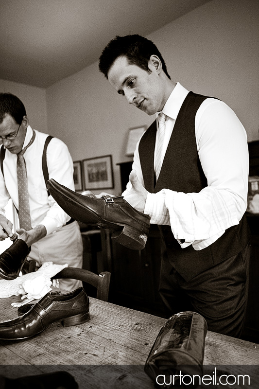 groom polishing his shoes at Borgo Iesolana - Bucine Tuscany Italy wedding